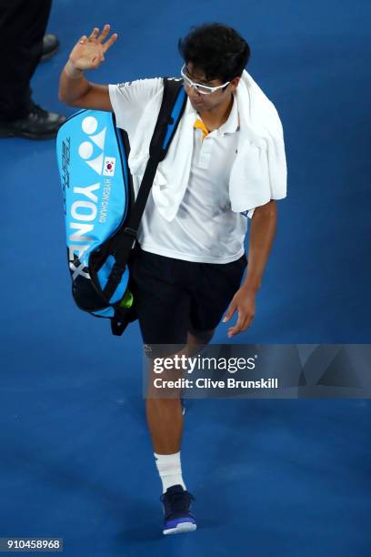 Dejected Hyeon Chung of South Korea waves to the crowd after retiring injured due to a blistered foot in his semi-final match against Roger Federer...