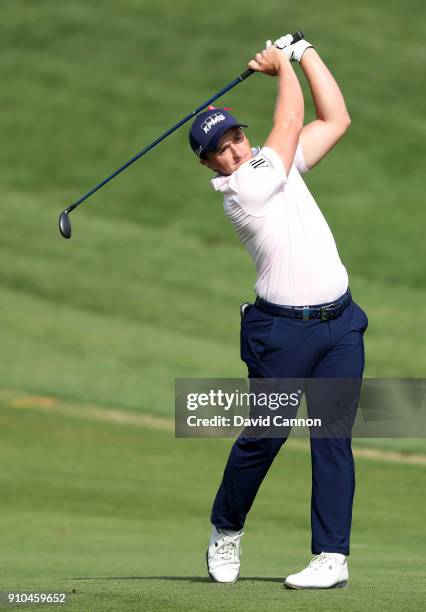 Paul Dunne of Ireland plays his second shot on the par 5, 10th hole during the second round of the Omega Dubai Desert Classic on the Majlis Course at...