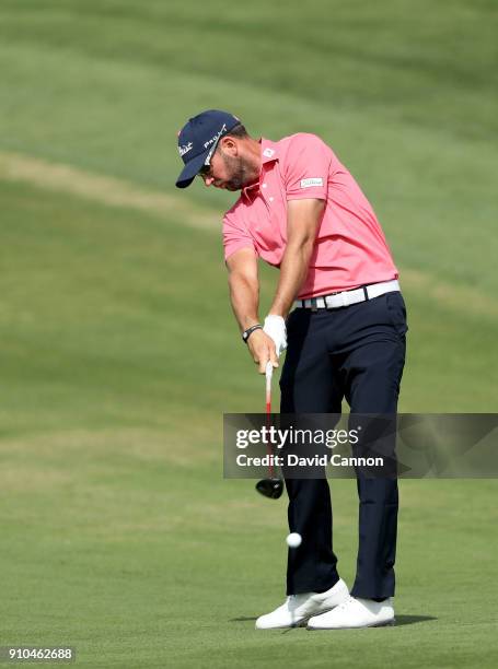 Scott Jamieson of Scotland plays his second shot on the par 5, 10th hole during the second round of the Omega Dubai Desert Classic on the Majlis...