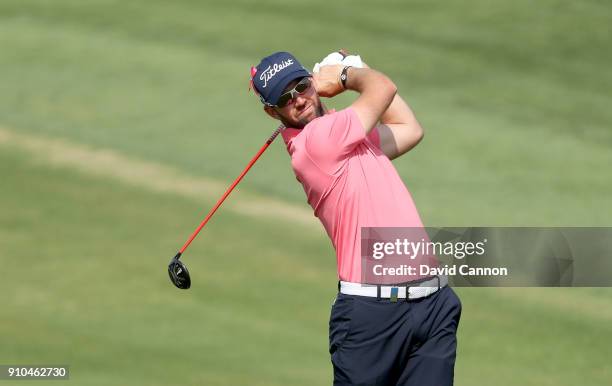 Scott Jamieson of Scotland plays his second shot on the par 5, 10th hole during the second round of the Omega Dubai Desert Classic on the Majlis...