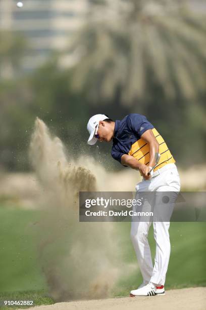 Haotong Li of China plays his second shot on the par 4, 14th hole during the second round of the Omega Dubai Desert Classic on the Majlis Course at...