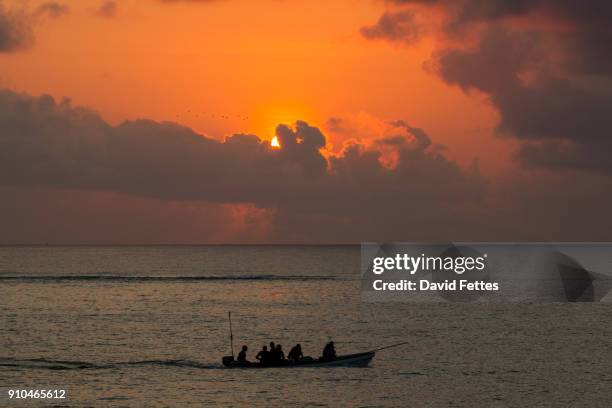 seascape with silhouetted fishing boat at sunset, zanzibar,tanzania, africa - zanzibar eilandengroep stockfoto's en -beelden