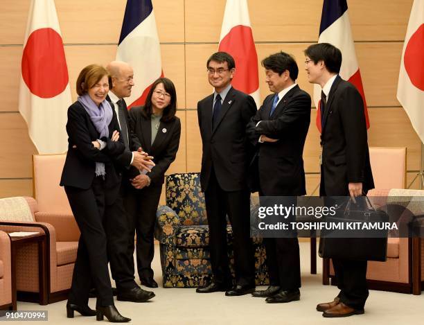 French Foreign Minister Jean-Yves Le Drian and French Defence Minister Florence Parly chat with Japanese Foreign Minister Taro Kono and Japanese...