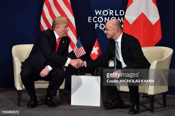 President Donald Trump shakes hands with Swiss President Alain Berset during a bilateral meeting on the sideline of the annual meeting of the World...
