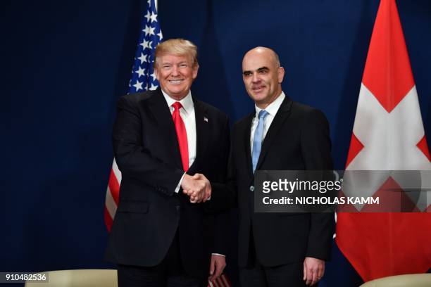 President Donald Trump shakes hands with Swiss President Alain Berset during a bilateral meeting on the sideline of the annual meeting of the World...