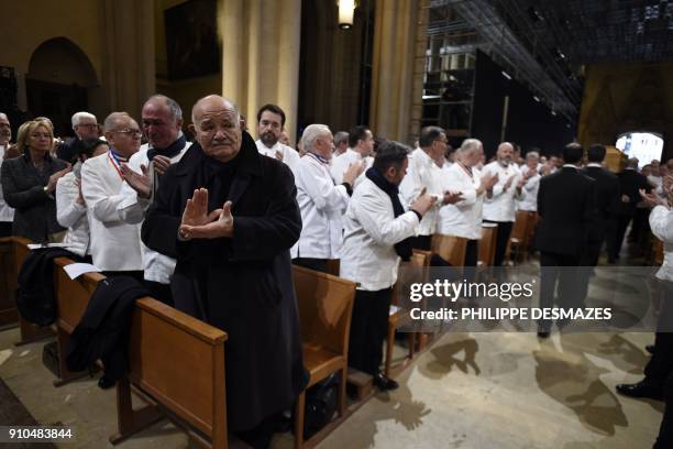 French chef Pierre Troisgros applauds as the coffin of French chef Paul Bocuse leaves the Saint-Jean Cathedral in Lyon on January 26, 2018 at the end...