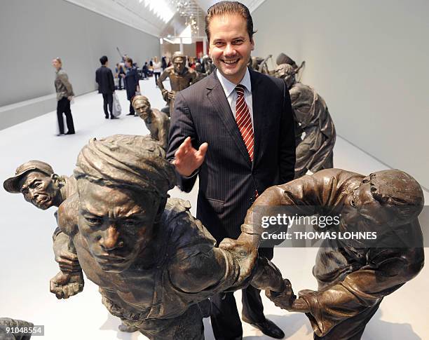 Gallery director Max Hollein poses for a photo with sculptures of the exhibition "Art for millions - 100 sculptures from the Mao era" at the Schirm...