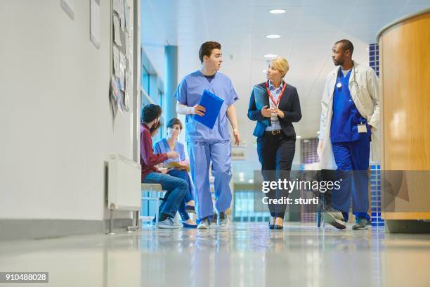 medical business - surgeon walking stock pictures, royalty-free photos & images