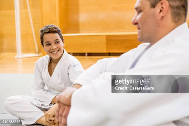 teenage boy and an adult in kimono relaxing and socializing - teachers pet stock pictures, royalty-free photos & images