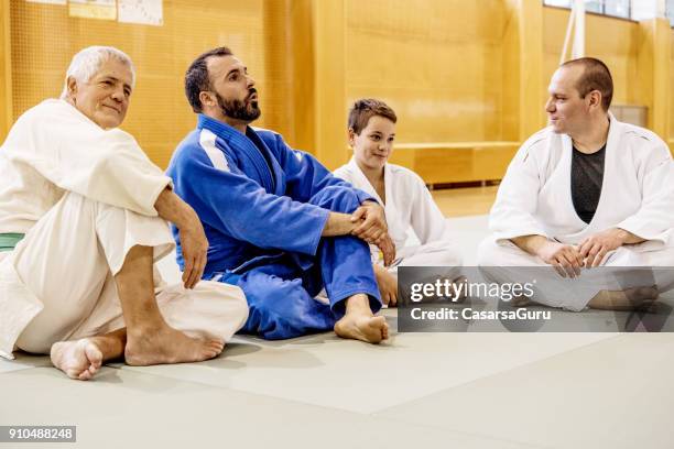 group of people in kimono relaxing and socializing - martial arts stock pictures, royalty-free photos & images