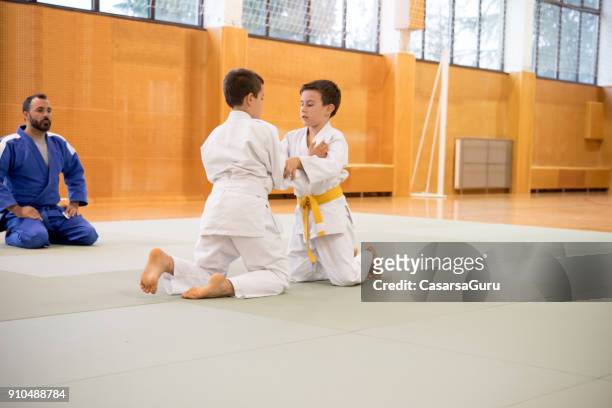 two boys training a judo fighting - judo kids stock pictures, royalty-free photos & images