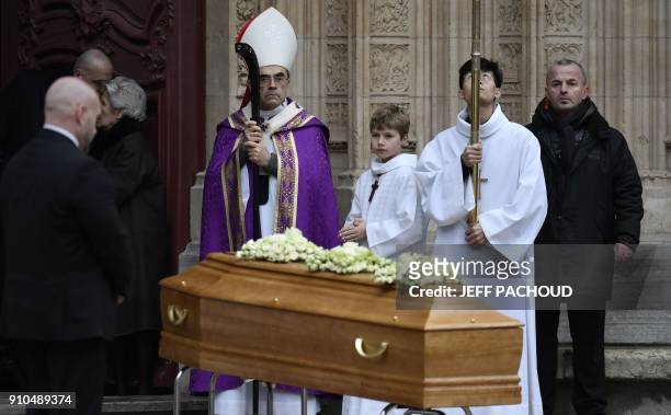 Lyon's Archbishop Cardinal Philippe Barbarin stands by the coffin French chef Paul Bocuse outside the Saint-Jean Cathedral in Lyon on January 26,...