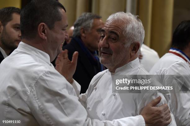 French chefs Christophe Marguin and Guy Savoy talk as they arrive to attend the funeral ceremony for French chef Paul Bocuse at the Saint-Jean...