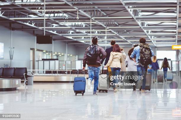 back view of people running with suitcase at airport terminal - priority boarding stock pictures, royalty-free photos & images