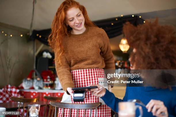 customer in cafe making contactless payment with mobile phone - waitress stock pictures, royalty-free photos & images