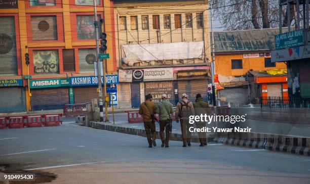 Indian government forces patrol the deserted city center during India's Republic Day on January 26, 2018 in Srinagar, the summer capital of Indian...