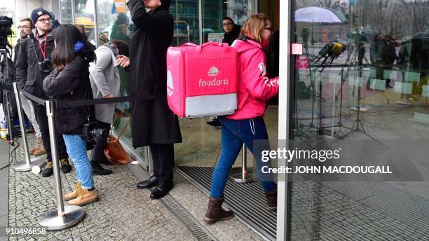 Foodora" delivery service courier enters the Konrad Adenauer building, the Christian Democratic Union headquarters as coalition talks to form a new...