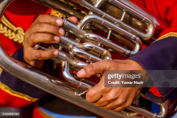 An Indian policeman holds a musical instrument at the Sher- i- Kashmir stadium, where the authorities held the main function during India's Republic...