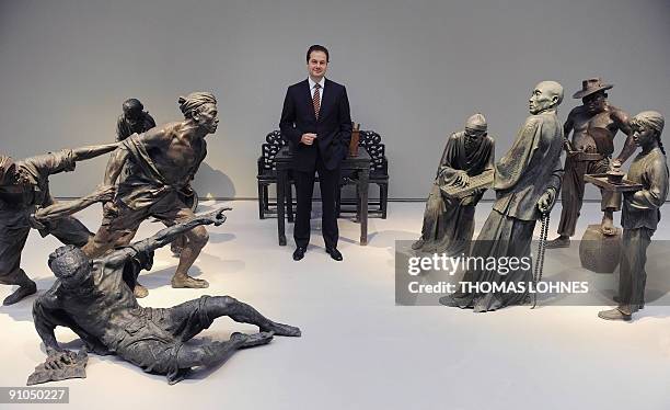 Gallery director Max Hollein poses for a photo with sculptures of the exhibition "Art for millions - 100 sculptures from the Mao era" at the Schirm...