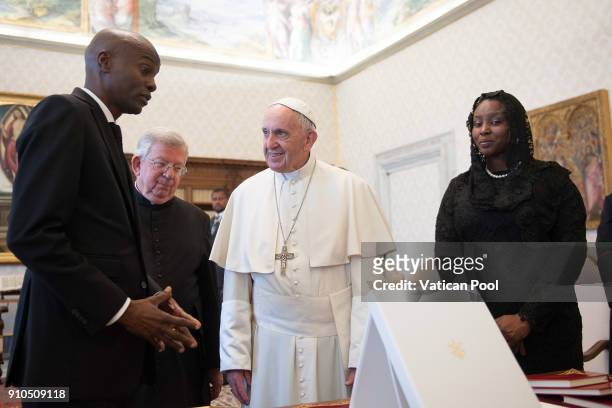 Pope Francis exchanges gifts with President of Haiti Jovenel Moise and his wife during an audience at the Apostolic Palace on January 26, 2018 in...