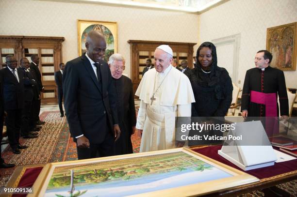 Pope Francis exchanges gifts with President of Haiti Jovenel Moise and his wife during an audience at the Apostolic Palace on January 26, 2018 in...