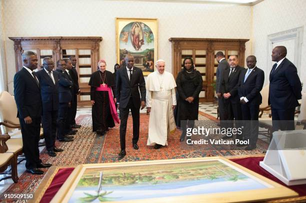 Pope Francis exchanges gifts with President of Haiti Jovenel Moise and his wife during an audience at the Apostolic Palace on January 26, 2018 in...