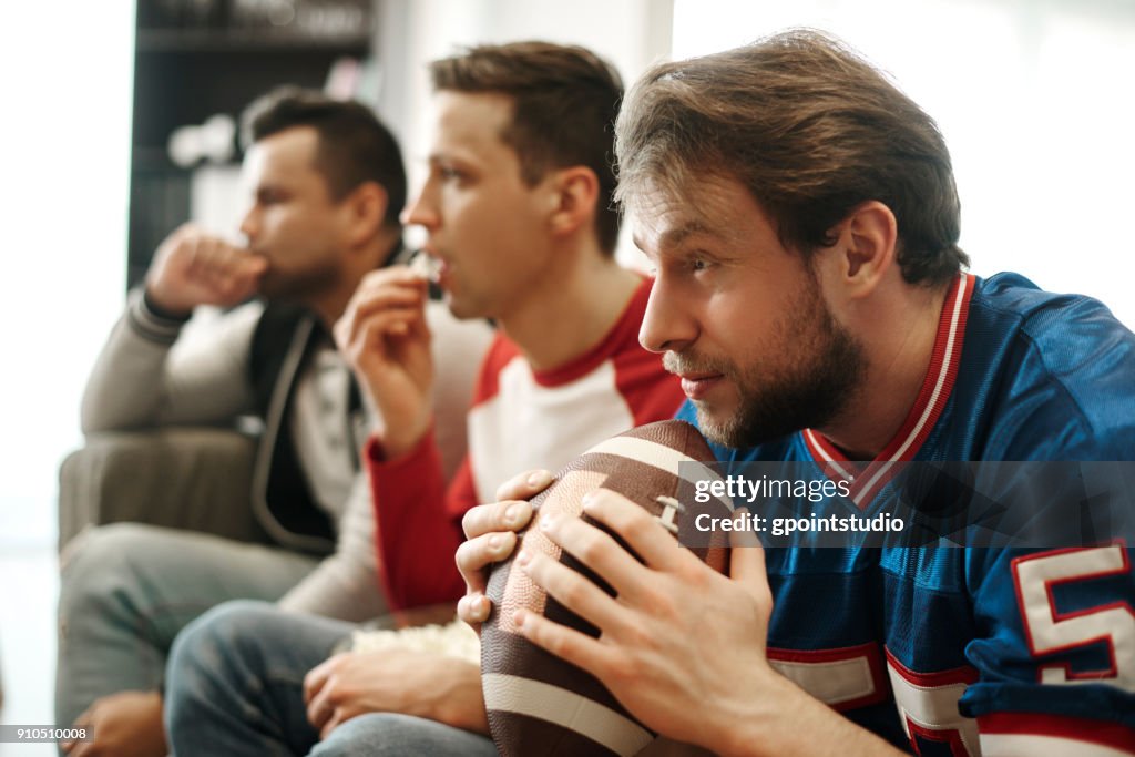 Focused watching football game at home