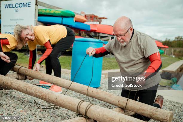 building a raft team building - team building activity stock pictures, royalty-free photos & images