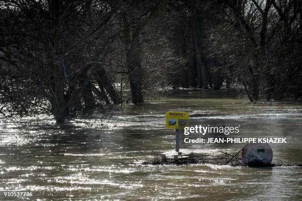 This picture taken on January 22, 2018 in Grigny shows the flooded banks of the Rhone river. - France braced for floods on January 23 as the Rhine...