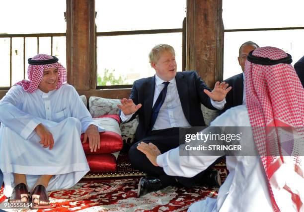 Saudi Foreign Minister Adel al-Jubeir sits with his British counterpart Boris Johnson as they tour the Nassif House in the historic quarter of Jeddah...