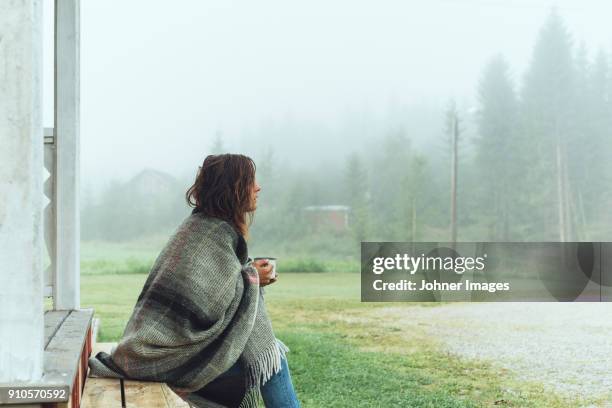 woman in a blanket having coffe - seasonal sadness stock pictures, royalty-free photos & images