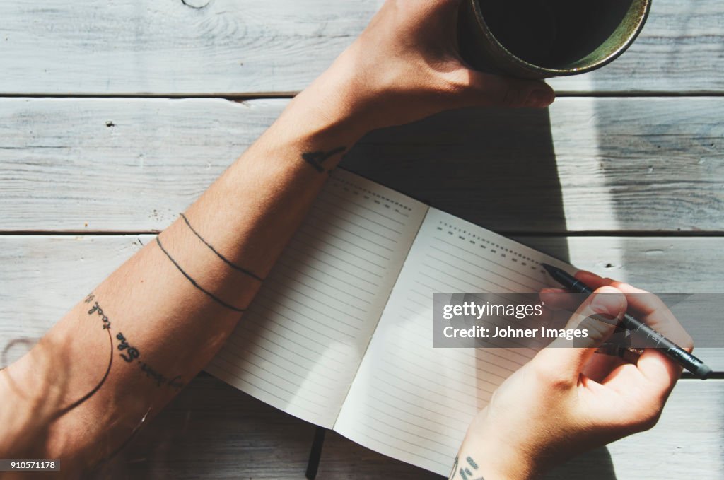 Woman writing in a notebok