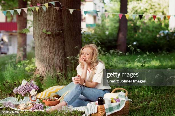 woman having a picknick - picknick stock-fotos und bilder