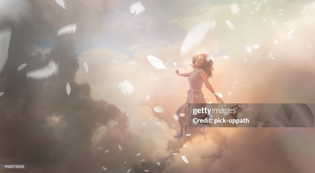 Angel in sky with falling feathers