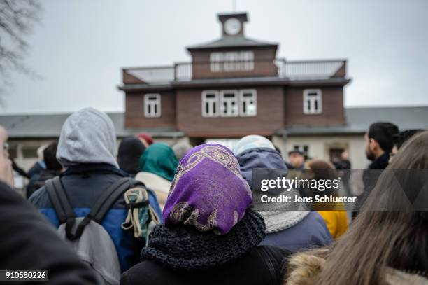 Syrian refugee stands in front of the entrance to the Buchenwald concentration camp memorial to commemorate victims of the Holocaust on January 26,...