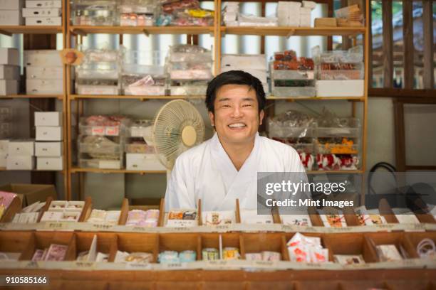 salesman wearing white kimono at shinto sakurai shrine, fukuoka, japan. - shinto shrine stock pictures, royalty-free photos & images