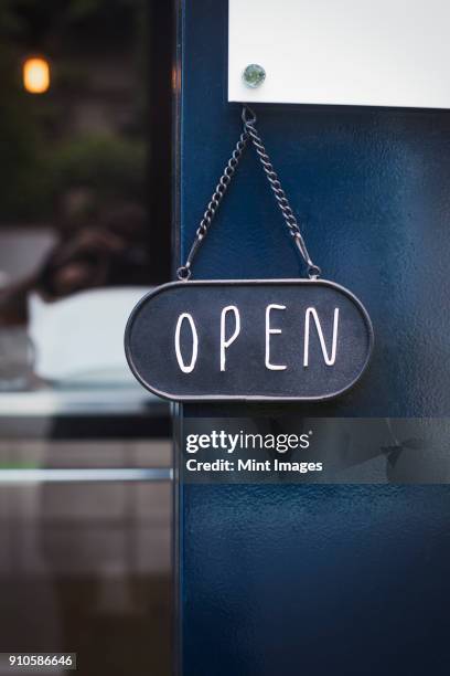 close up of open sign on glass door to a bakery. - open sign on door stock-fotos und bilder