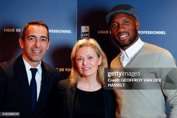 French Ligue de football professionnel's president Nathalie Boy de La Tour , poses with French former football player Youri Djorkaeff and Ivory Coast...