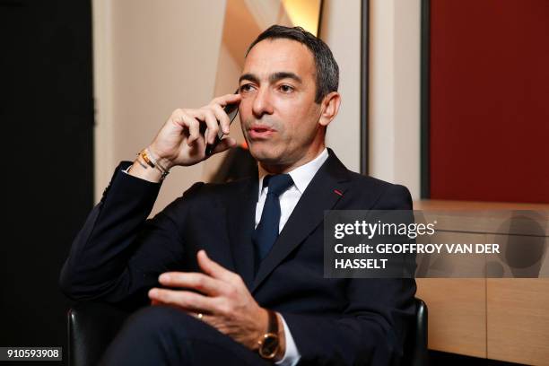 French former football player Youri Djorkaeff, named ambassador of the Ligue de football professionnel speaks on the phone in Paris on January 25,...