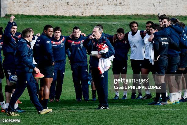 France's rugby union team coach Jacques Brunel talks to his players during a training session on January 26, 2018 at the team's training camp in...