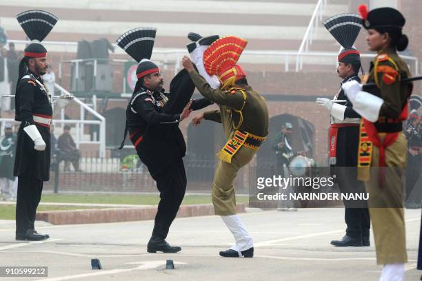 Pakistani Rangers and Indian Border Security Force personnel take part in the daily beating of the retreat ceremony during India's 69th Republic Day...