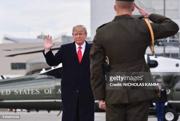 President Donald Trump waves before boarding the Air Force One ahead of his departure from Zurich Airport in Zurich on January 26 after attending the...