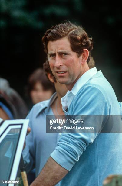 Prince Charles leans on his car at Cowdray Park Polo Club in Sussex on August 2, 1982