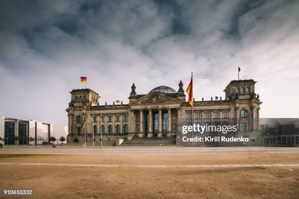 reichstag under stormy clouds on a winter day - berlin reichstag stock pictures, royalty-free photos & images