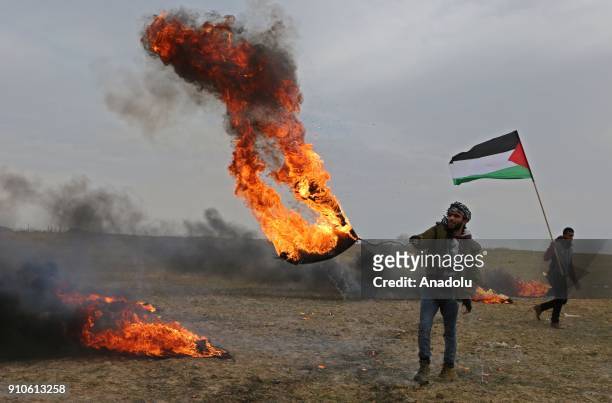 Palestinian protesters burn tyres during a protest against U.S. President Donald Trumps announcement to recognize Jerusalem as the capital of Israel,...