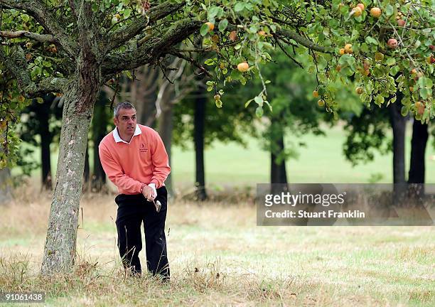 Great Britian and Northern Ireland Captian Paul McGinley of Ireland watches his shot from under an apple tree during the pro - am at The Vivendi...