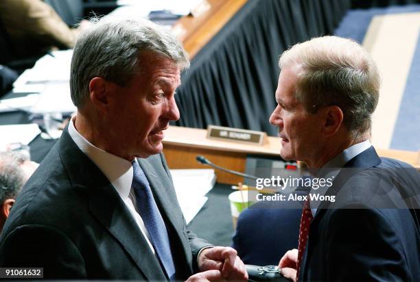 Committee Chairman Sen. Max Baucus talks to Sen. Bill Nelson during a mark up hearing before the U.S. Senate Finance Committee on Capitol Hill...