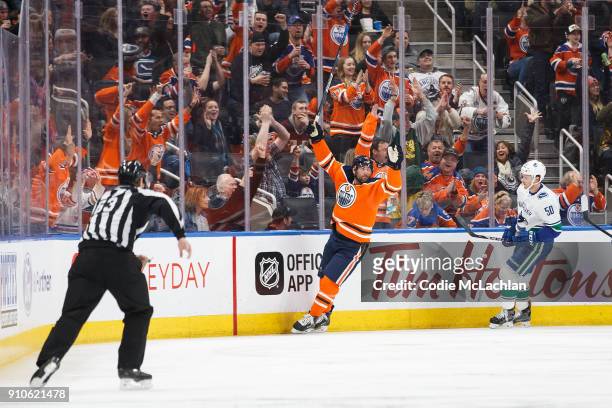 Patrick Maroon of the Edmonton Oilers celebrates a goal as Brendan Gaunce of the Vancouver Canucks reacts at Rogers Place on January 20, 2018 in...