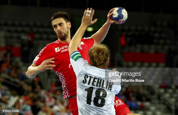 Marko Kopljar of Croatia challenges Jan Stehlik of Czech Republic during the Men's Handball European Championship placement match between Croatia and...