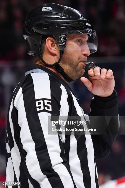 Linesman Jonny Murray blows his whistle during the Carolina Hurricanes versus the Montreal Canadiens game on January 25 at Bell Centre in Montreal, QC